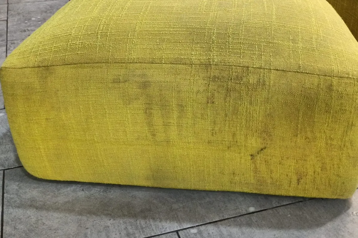 Yellow fabric sofa seat with heavy soiling before deep cleaning by Pest Orbit