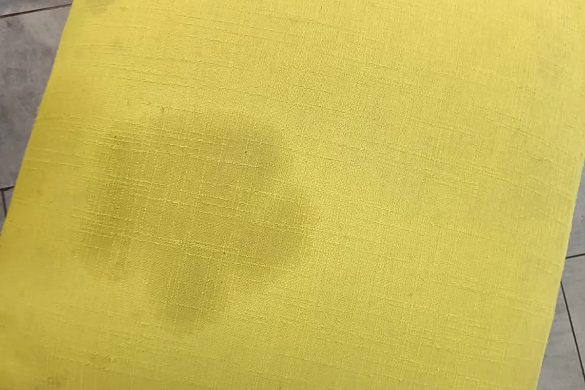 Office sofa upholstery showing stains and traffic marks before cleaning