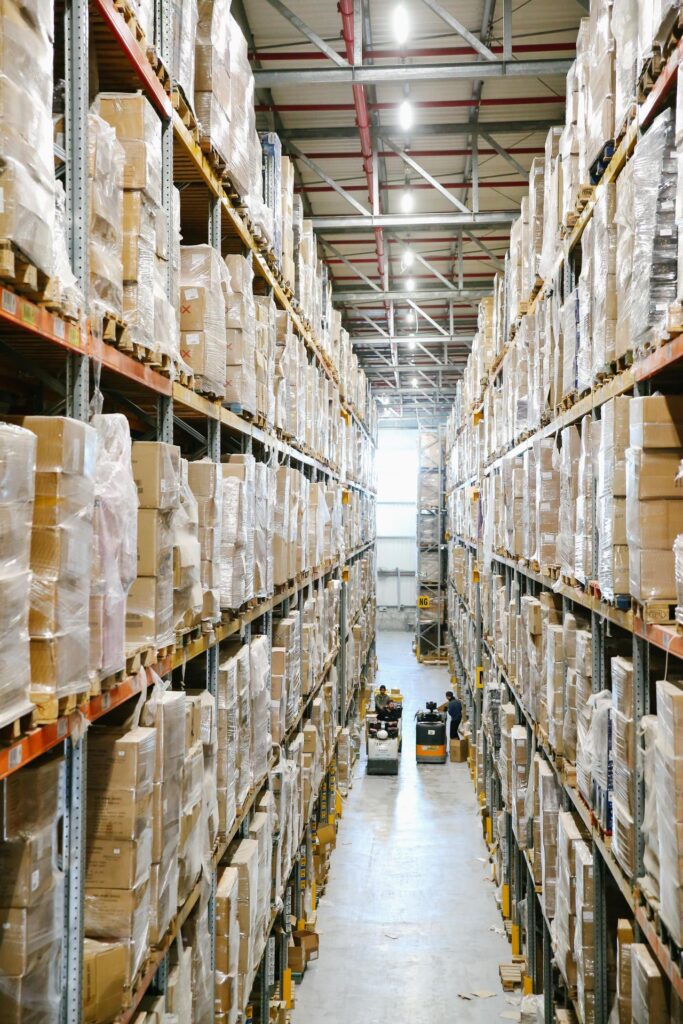Illustrative warehouse aisle with shelves of boxed stock