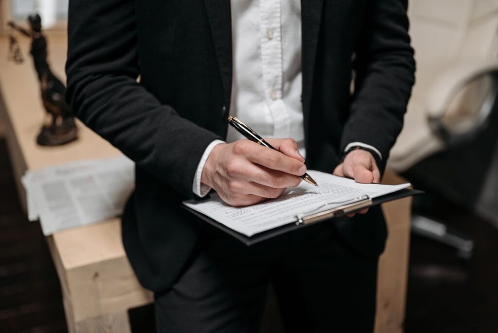 A professional completing paperwork on a clipboard